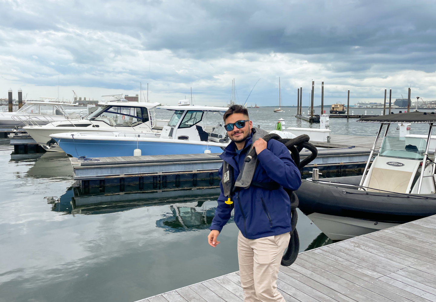 Boston Yacht Haven staff wearing a life jacket at work in recognition of Safe Boating Week